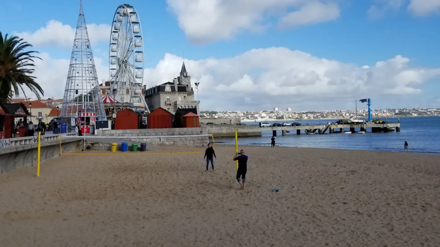 Beach volleyball court with sand, net, and boundary lines